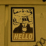 goatse sticker with graffiti on paneled wall