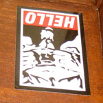 hello goatse sticker on a wall