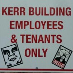 Goatse sticker and Obey sticker on parking sign in Montana